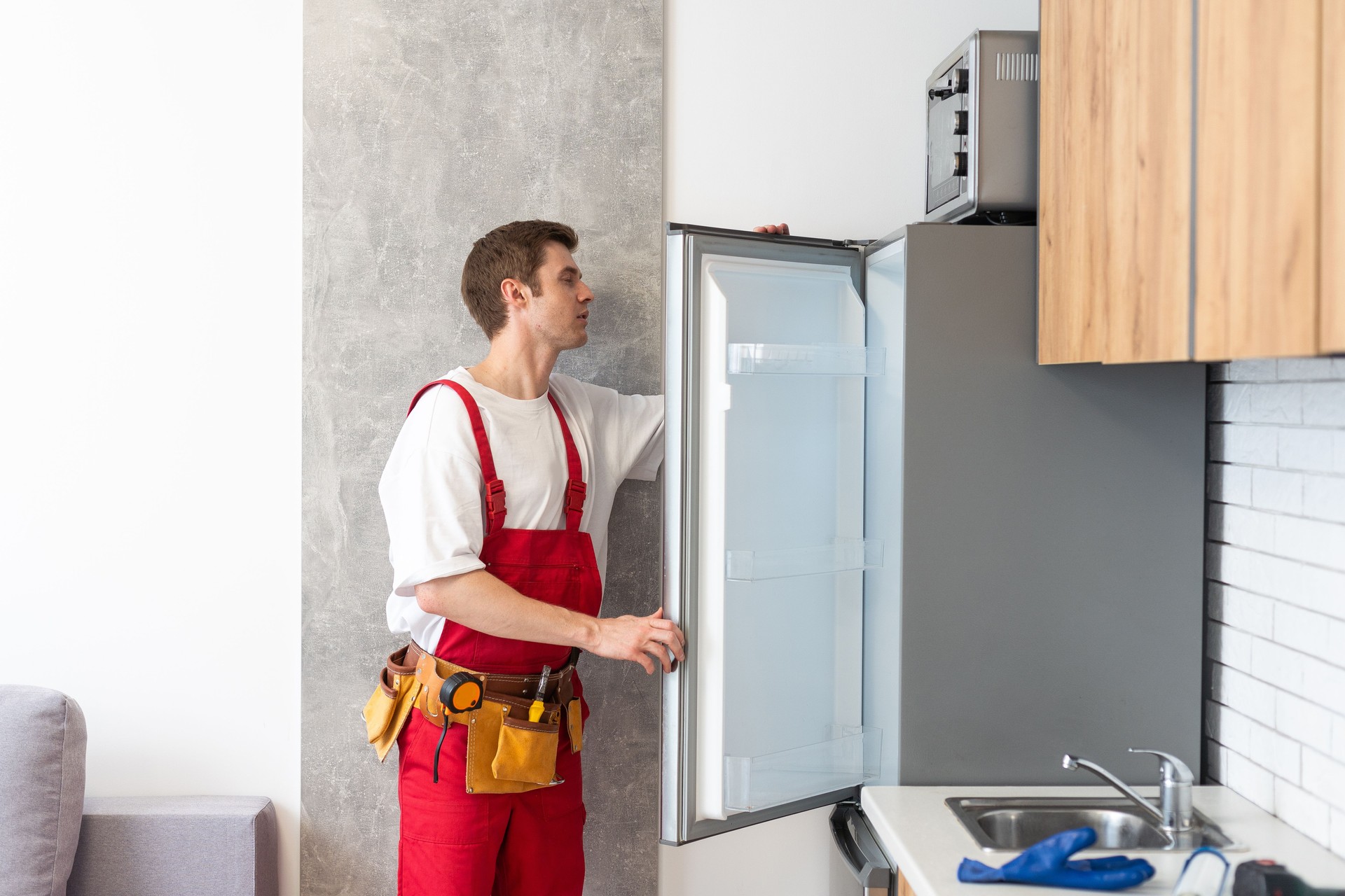 Electrician Technician Working To Repair Refrigerator Or Fridge Appliance